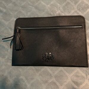 KVD Black, NWOT, never used make up bag. Front zipper pocket with black tassel.